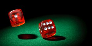 Red dice against a green casino table