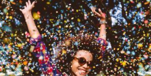 woman celebrating under confetti
