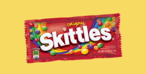 Package of Skittles on a yellow background